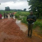 Agricultural advisor Lilian Sangamakole on the flooded road.